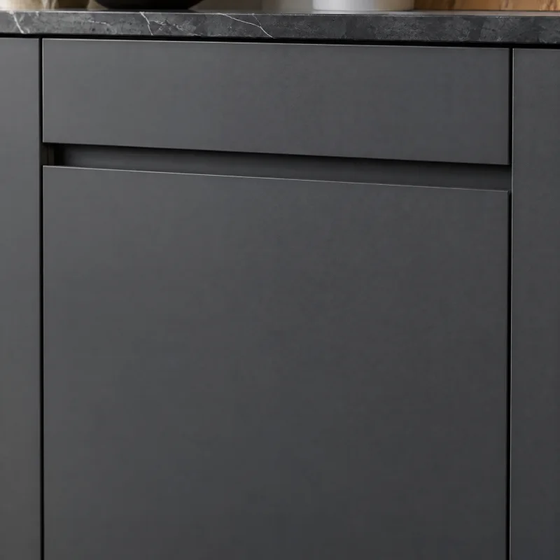 Close-up of a matte charcoal flat-panel cabinet door with an integrated top-edge finger pull and no visible hardware