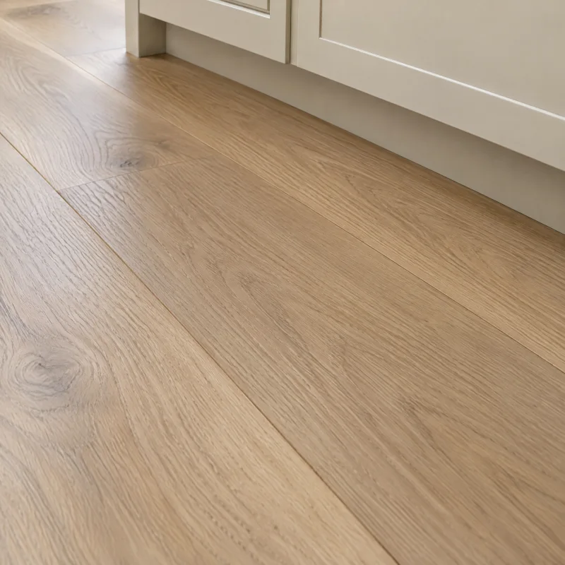 Close-up of wide white oak floor planks with a matte natural finish and a soft straight grain